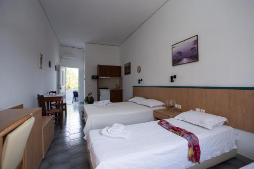 a hotel room with two beds and a kitchen at SUN -RISE in Perissa