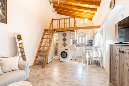 a living room with a staircase and a kitchen at Alicia's Traditional Home In Paradisi in Paradeísion