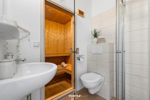 a bathroom with a toilet and a sink and a shower at Ferienhaus Spitzenblick 2 - Sankt Andreasberg im Harz in Sankt Andreasberg