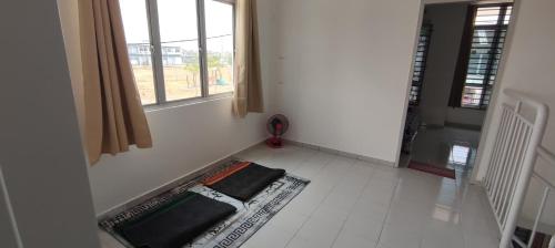 a room with a window and a rug on the floor at Arif & Asna Family's HOMESTAY in Pasir Mas