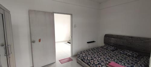 a bedroom with a bed and a large mirror at Arif & Asna Family's HOMESTAY in Pasir Mas