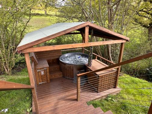 a gazebo with a hot tub on a deck at Luna Domes in Chiddingstone