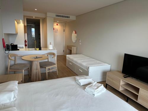 a living room with a bed and a kitchen at New Douro 406 with parking in Vila Nova de Gaia