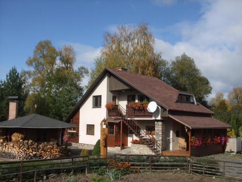 a large white house with a porch and a balcony at Privát Prima in Liptovský Ján