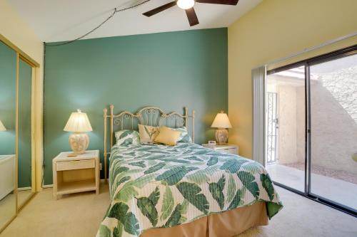 a bedroom with a bed and two night stands with lamps at Golf Course Condo with Patio in Cathedral City! in Cathedral City