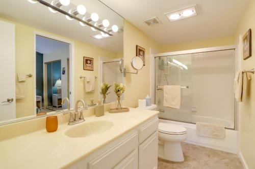 a white bathroom with a sink and a toilet at Golf Course Condo with Patio in Cathedral City! in Cathedral City