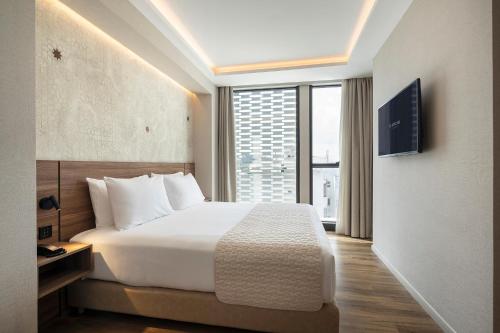 a hotel room with a bed and a large window at Eurostars Casa Anfa in Casablanca