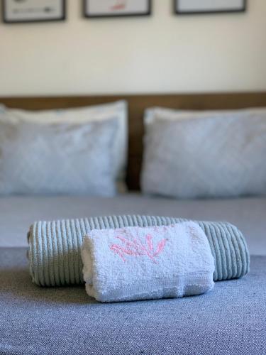 a towel sitting on top of a bed at Apartamento Fonte Velha in Nazaré