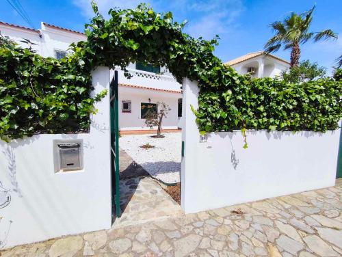 a gate to a house with ivy on it at Albufeira INN - Mulatinho V3 in Olhos de Água