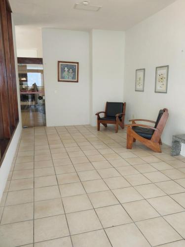 a room with two chairs and a tiled floor at Flat beira mar, Olinda 4 Rodas 309 in Olinda