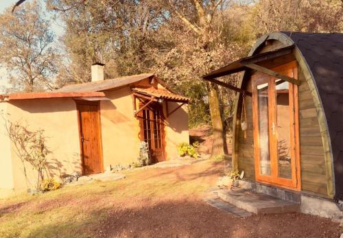 a tiny house with a door and a porch at Espacio acogedor en la montaña in Sant Jaume de Llierca