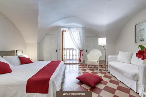 a bedroom with a white bed and a couch at Le Stanze del Poeta Rooms - Lecce Selection in Lecce