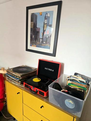 a desk with a laptop and records on it at Inalong - Quirky property with sea views above an Ale House in The Mumbles
