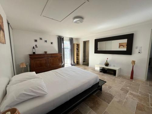 a bedroom with a large white bed and a mirror at Villa Hésperides 5 mins de Disneyland Paris in Magny-le-Hongre