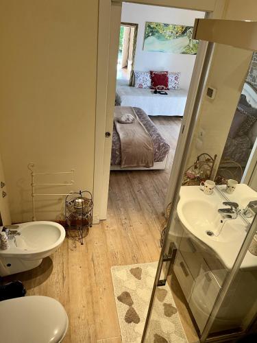 a bathroom with a sink and a mirror and a bed at Country Home B&B Il Melo in Vicenza
