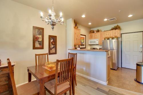 a kitchen and dining room with a table and a refrigerator at Overgaard Condo with Balcony, Near Hiking and Golfing in Overgaard