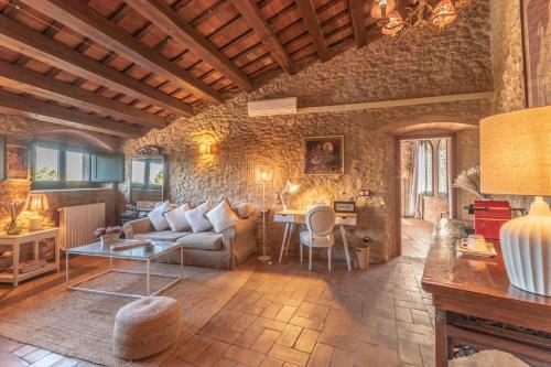 a living room with a couch and a table at El Racó de Madremanya - Adults only in Madremanya