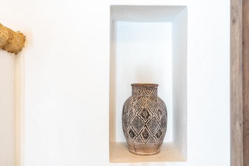 a vase sitting on a shelf in a room at Alicia's Traditional Home In Paradisi in Paradeísion