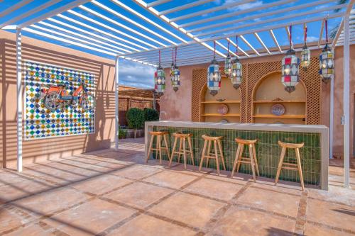 a patio with a bar with stools at Palais Noryalis in Tillouna