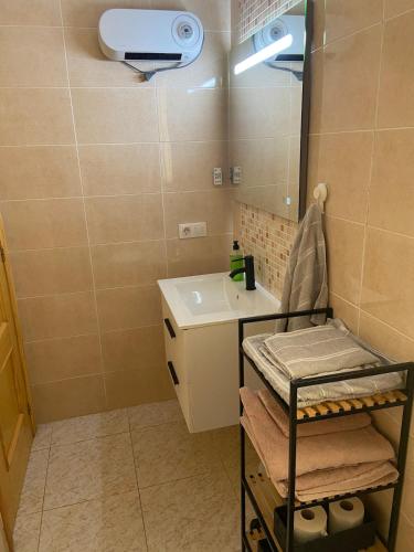 a small bathroom with a sink and a mirror at Apartamento playa de chilches in Chilches