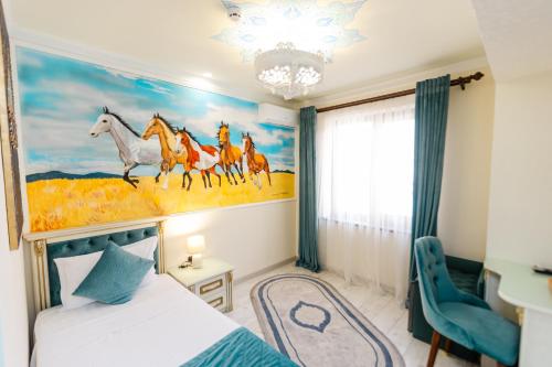 a bedroom with a painting of horses on the wall at Gur Emir Palace boutique hotel in Samarkand