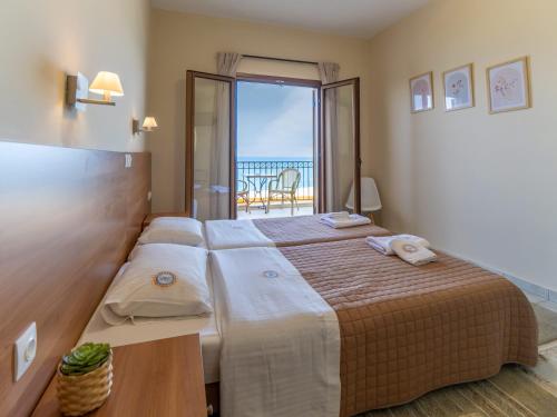 Postel nebo postele na pokoji v ubytování Sunset Hotel