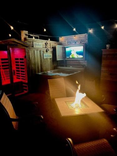 a room with a tv and a table with a candle at Reno Romantic Couples Retreat in Reno