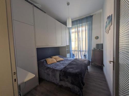 a bedroom with a bed and a large window at Vr Albenga in Albenga