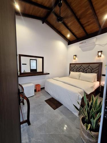 a bedroom with a large bed and a mirror at Adrian Dilneth in Weligama
