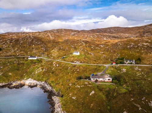 an aerial view of a house and a road on a mountain at 2 Carrigreich in Scalpay