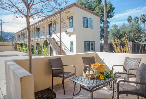 a patio with chairs and a table and a house at Casa Ojai Inn in Ojai