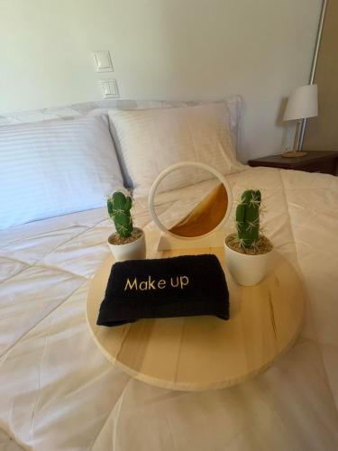 a bed with a table with a sign that says make up at Alex house in Kouramaditika