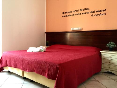 
a hotel room with a bed and a desk at Mamamia Lipari in Lipari
