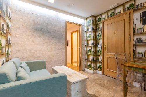 a living room with a couch and a table at H-A Aparthotel Hotel Quo in Madrid