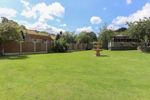 a yard with a fire hydrant in the grass at Wend Gardens Studio Carleton Skipton Pet Friendly in Skipton
