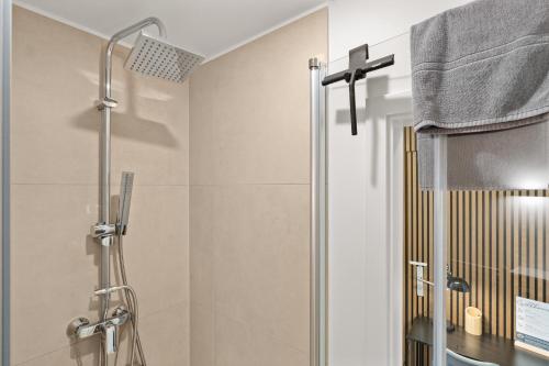 a shower with a glass door in a bathroom at City-Apartment - Kurze Wege zu Messe und LanxessArena in Cologne