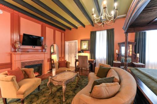 a bedroom with orange walls and a bed and a fireplace at Casa De Solana Bed and Breakfast in St. Augustine