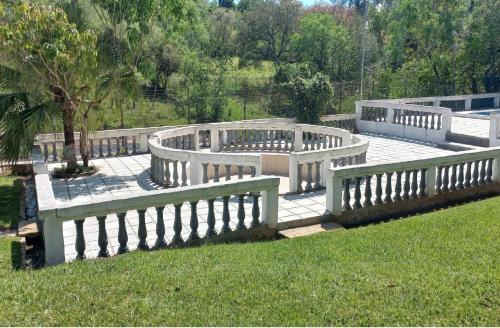 a group of benches sitting on a patio at Los Cantares in Piribebuy