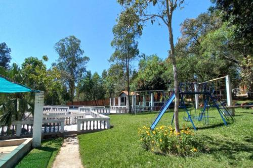 a playground with a slide in a park at Los Cantares in Piribebuy