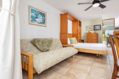 a bedroom with a bed and a couch at Kona Islander Inn#309 in Kailua-Kona