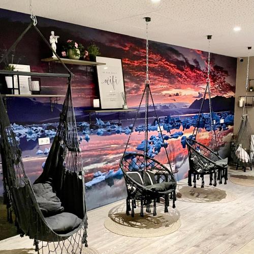 two swings in a room with a painting on the wall at Hotel Muli in Reykjavík