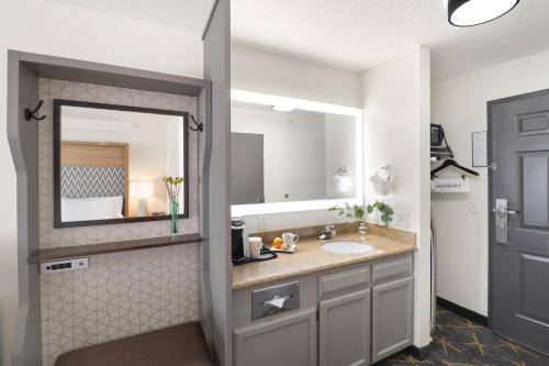 a bathroom with a sink and a mirror at Holiday Inn Redding by IHG in Redding