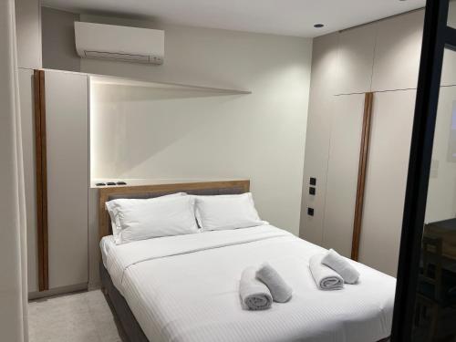 a bedroom with a bed with two towels on it at POST VIEW Center Luxury Apartments 5 in Ioannina