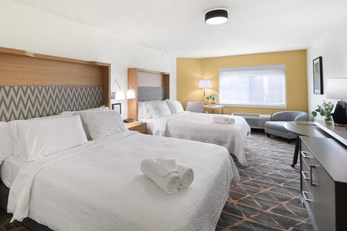 a hotel room with two beds with towels on them at Holiday Inn Redding by IHG in Redding