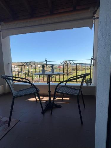 a table and chairs on a balcony with a view at Alex house in Kouramaditika