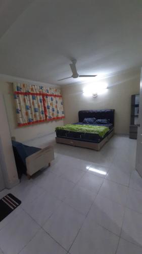 a room with a bed in the middle of it at Glory Homestay Ipoh in Ipoh