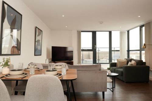 a living room with a table and a couch at Luxury York Minster Penthouse - Free Gym & Parking in York