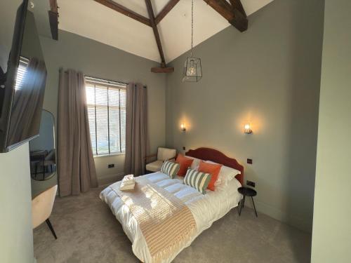 a bedroom with a bed and a window at Akroyd House - The Wainhouse Room in Halifax