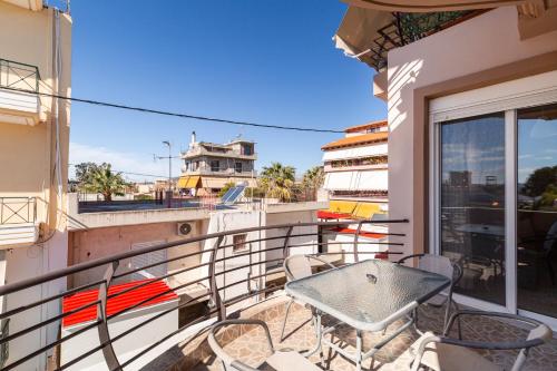 a balcony with a table and chairs on a building at House in Eleusis (Elefsina) a city close to Athens in Elefsina