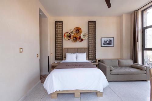 a bedroom with a large bed and a couch at Casa Filomeno in Mexico City